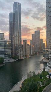 a view of a river in a city with tall buildings at JJ Luxury Apartment in London