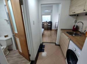 a small kitchen with a sink and a table at iNestin Shanghai Apt Lujiazui in Shanghai