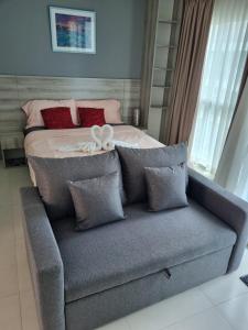 a bed with two white rings on top of a couch at Grandblue condominium 106,302 in Mae Pim