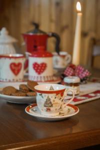 a table topped with cups and plates with cookies at LA GROTTA in Subiaco