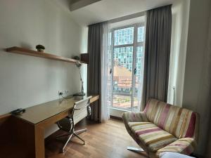 a room with a desk and a chair and a window at Cormar KLCC by NHB in Kuala Lumpur