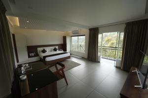 A bed or beds in a room at jungle view resort