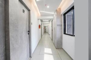 an empty hallway with a long corridor at FabHotel Aahan in Navi Mumbai