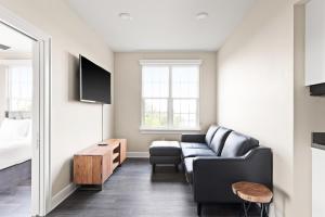 a living room with a couch and a table at Holy Angels Bywater Hotel and Residences in New Orleans