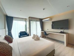 a hotel room with a bed and a flat screen tv at The 9 Residence Hotel in Bangkok