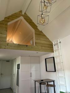 a room with a wooden ceiling and a table at Spa&House91 in Mennecy