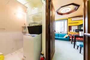 a room with a refrigerator and a dining room at Sprinkle inn in Sapporo
