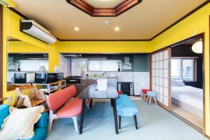 a room with a table and chairs and a bedroom at Sprinkle inn in Sapporo