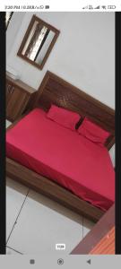 a bedroom with a bed with a red comforter at V.S guest houes in Palwal