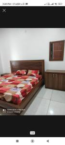 a bedroom with a bed with a red comforter at V.S guest houes in Palwal