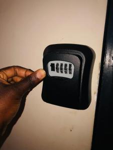 a hand is holding a black electrical outlet at Urban Escape in Nairobi