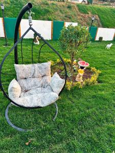 a swinging chair with a pillow in a yard at Joy Sapanca in Sapanca