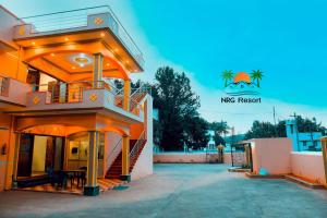 a view of the front of a house with the ms resort logo at NRG Resort in Yelagiri