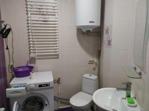 a bathroom with a washing machine and a sink at Квартира-студия с видом на море in Ureki