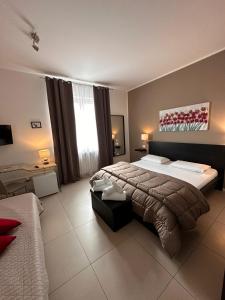a large bedroom with two beds and a window at Location10 in Palermo