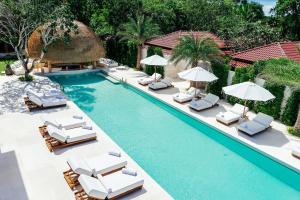 an image of a swimming pool with chairs and umbrellas at Zazen Boutique Resort & Spa in Bophut