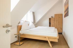 ein Schlafzimmer mit einem Bett im Dachgeschoss in der Unterkunft Schwalbennest 1-3 in Juist