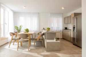 a kitchen and dining room with a table and chairs at Schwalbennest 1-3 in Juist