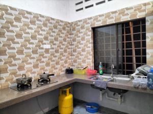 a kitchen with a sink and a counter top at E HOME 2 KULAI-Tatami house in Kulai
