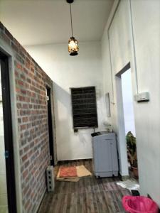 a room with a brick wall and a window at E HOME 2 KULAI-Tatami house in Kulai