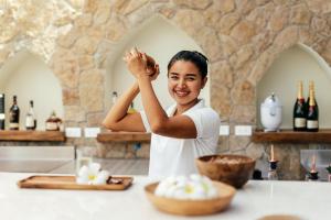 a man standing in a kitchen with his hand in the air at Zazen Boutique Resort & Spa in Bophut