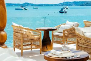 a table and chairs with a view of the water at Zazen Boutique Resort & Spa in Bophut