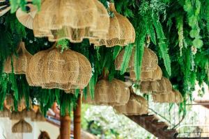 a bunch of straw umbrellas hanging on a wall at Zazen Boutique Resort & Spa in Bophut