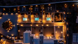 an aerial view of a building at night with lights at Santa Irina Luxury Sunny Lofts in Perivolos