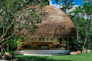 a pavilion with a table and a straw roof at Zazen Boutique Resort & Spa in Bophut