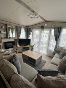 a living room with a couch and a table at Sun sea and sand at Whitley bay in Hartley