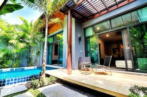a house with a pool and a table and chairs at Villa Casablanca in Ban Saiyuan (1)