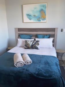 a bedroom with a bed with towels on it at City View Unit 130 at 77 on Independence in Windhoek