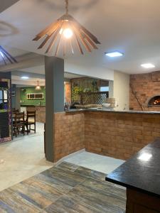 a kitchen and dining room with a large light fixture at Tamandaré Praia Hotel in Tamandaré