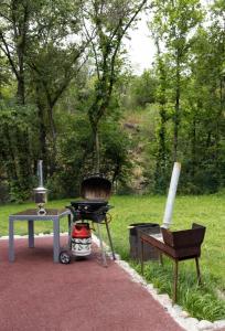 a bbq and a grill and a table at Коттедж «Большая станица» in Almaty
