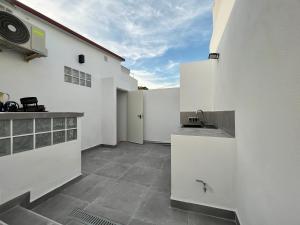 a kitchen with white walls and a counter and a sink at Morgan apartamentos Marbella centro in Marbella