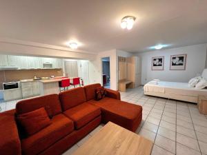 a living room with a couch and a bed at Kouros City Center in Kavala