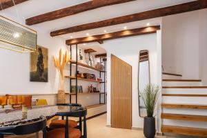 a room with a staircase and a table and chairs at Villa Lemonia in Rethymno Town