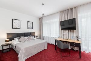 Łóżko lub łóżka w pokoju w obiekcie Hotel Łaziska