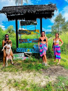 a group of three women standing in front of a sign at Freedom home in Ko Chang
