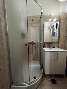 a bathroom with a shower and a sink at Kouros City Center in Kavala