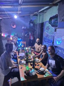 a group of people sitting around a table at Family Hostel in Lovina