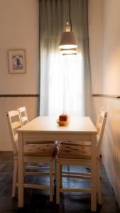 mesa de comedor con sillas y lámpara en Apartamentos Entreteatros, fantástico duplex casco histórico, en Talavera de la Reina