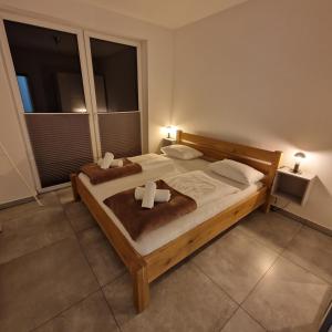 a bedroom with two beds and a large window at Apartamenty KADO (MATEJKI) in Karpacz