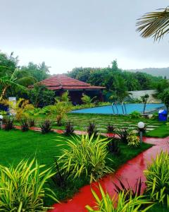 a resort with a swimming pool and a resort at White Truffle Resort, Arambol in Arambol