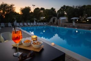 un drink su un tavolo accanto alla piscina di Centro Vacanze Piccolo Friuli a Vieste