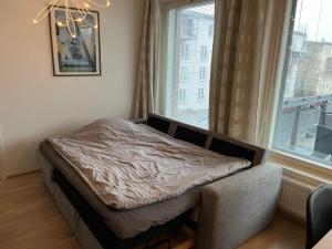 a small bed in a room with a window at Pro Apartments 5 in Vaasa