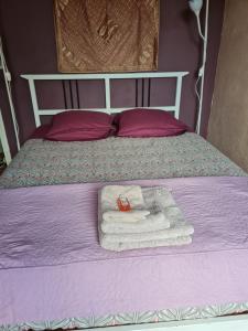 a pile of towels sitting on top of a bed at Chez Hélène in Bordeaux