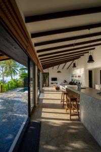 an open kitchen and dining area of a house at Lunar Villas Koh Tao - Luxury Private Pool Villas in Ko Tao