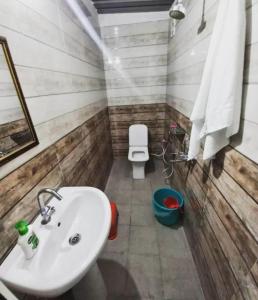 a bathroom with a sink and a toilet at The FnF Resort & Camping - Rishikehs in Rishīkesh