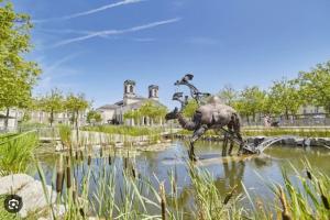 a statue of a dinosaur in a pond at Hyper Centre La Roche sur Yon - Appartement spacieux et lumineux in La Roche-sur-Yon